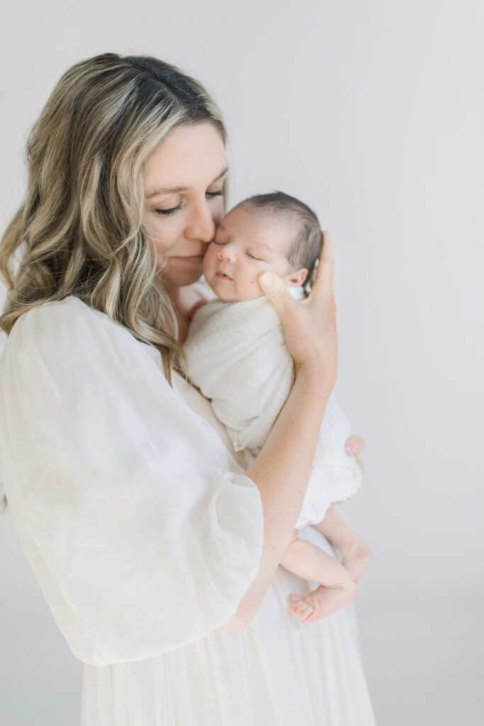 Newborn and mother snuggling motherhood session